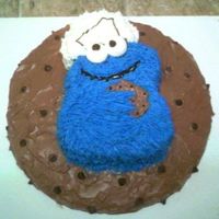 Cookie Monster On A Cookie Chocolate cake - made the bottom round to look like a cookie with real choco chips on it. Cookie Monster is chocolate cake also with...
