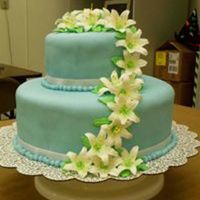 Blue Fondant With Day Lilies This was my first stacked cake for my final of my last Wilton class. Blue fondant with a satin ribbon around each layer. Made the flowers...