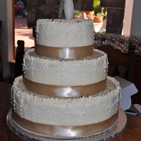 Buttercream Wedding Cake With Ivory Stringwork With Taupe Ribbon This was white cake with a layer of apricot jam pureed then a layer of white chocolate pudding on top of that for the filling. It was an...