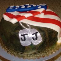 J.j.'s Military Cake I made this for a friend who left for war this year. It's a camoflage fondant covered vanilla cake, an american flag, and a set of dog...