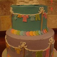 Clothes Line Baby Shower Lots of little baby clothes cut out of fondant. Clothes basket with baby clothes on the top.