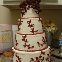 Sarah's Wedding Cake This was for my little sisters wedding yesterday. The cake is not lopsided it is on a crocked spinny thing. The desighn isn't the best...