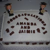 Grad Cake 1/2 chocolate & 1/2 yellow cake, filled with butter cream and iced with butter cream. The letters and pics are milk chocolate and they...