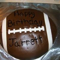 Football This is a half yellow half chocolate carved football cake, carved from 2 12inch cakes. Covered in mmf with mmf white accents, textured with...