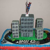 Austin's Cake Spiderman and Cars Cake. Cake is chocolate WASC cake. Iced in BCD. The road is made of MMF and the buildings are MMF covered styrofoam....