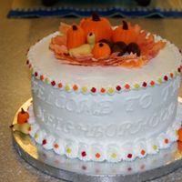 Welcome To The Neighborhood For Our New Neighbors 2-layer, 9" with buttercream. The pumpkins, squash and acorns are fondant. The tiny leaves on the borders are from the Wilton Fall...