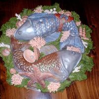 Fruits Of The Sea For a fisherman's retirement. Cakes baked in jelly mold for basic shape, covered in fondant and luster-dusted. Sugar shells, starfish...
