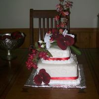 White Fondant With Orchids This cake was made for a 40th anniversary party. Proof positive that even the biggest flaws can be covered with embellishments! I used...