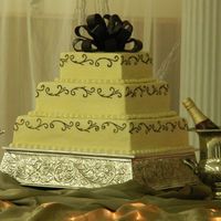 Square Wedding Cake, Ivory With Scrollwork, Chocolate Fondant Bow This is my beautiful daughter-in-law's cake that I made for their wedding this past weekend. She chose an Ivory square cake, with...