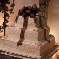 Square Wedding Cake With Chocolate Fondant Bow This cake was chosen by the bride on Cakecentral, (JENN123). Added the fleur-de-lis details to cover the corners of the plastic divider...
