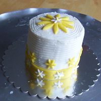Yellow Flowers Cake Buttercream and fondant covering a yellow gold cake.