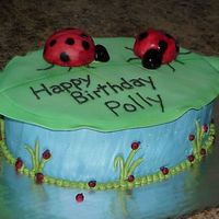 Lady Bugs this is a lady bug birthday cake ladybugs Are Made from cupcakes and fondant.