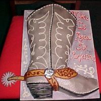 Cowboy Boot Sculpted boot cake, iced with buttercream, airbrushed and overpiped.