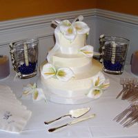 Ribbons And Lillies Smooth buttercream cake decorated simply with satin ribbon bands and bow and calla lillies.