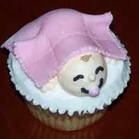 Sleeping Baby Cupcake ...Got the idea from a Wilton cupcake decorating book. I used buttercream instead of fondant for the baby. Blanket is obviously fondant....
