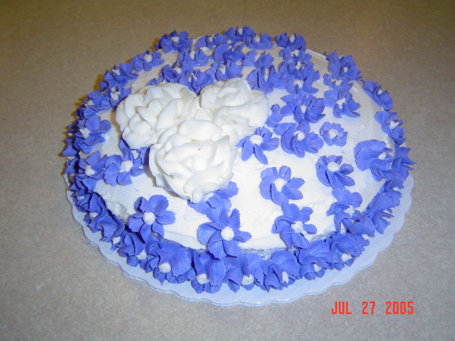 Yellow Cake With Purple And White Buttercream Flowers I just made this cake to practice what we've been learning in my Wilton I class. I got the idea out of the Wilton I book, but added...
