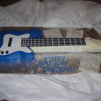 Brandon's Guitar i carved an 11x15 sheet for the body of the guitar and shaped rice crispy treats for the neck. Poured white chocolate ganache over the...