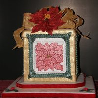 Christmas Present Cake With Poinsetta And Bow This was my OSSAS entry. Poinsetta was hand drawn w/#2 tip and veining was done with #00. Bow is gumpaste. Border is a long line of the...