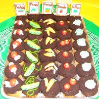Farm Harvest Cupcakes Cupcakes with buttercream icing, Cookie crumb "dirt", veggies are made from a variety of candies.