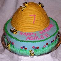 Bee Hive Birthday The hive was made with the Wilton wondermold. Frosted in BC, fondant flowers around base, bees on base are BC- bees on hive are mmf.