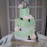 Magnolia Wedding I like this cake even though the middle tier came out too large. All butercream with gumpaste magnolias.