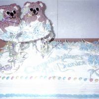 Twins! I made this cake for a friend having twins. I used a half sheet pan and Wilton's mini 3-d bear pan.The "rattles are lolli-pops!