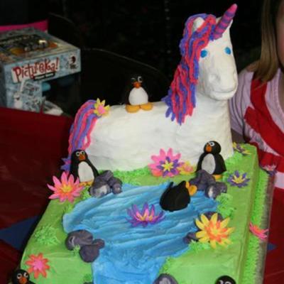 Unicorn Cake With A Penguin On It's Back
