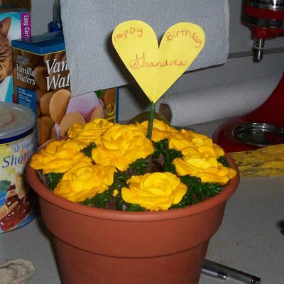Rose Cupcakes On Dirt Cake In Flower Pot.