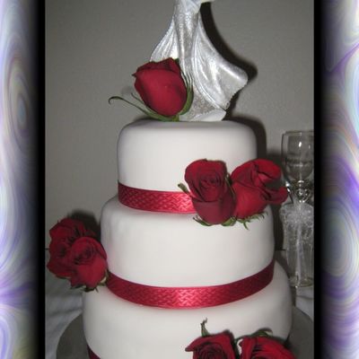 Wedding Cake With Red Roses And Ribbon