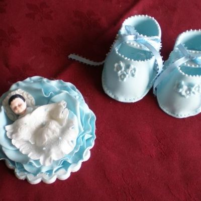 Baby Booties And Baby In A Rose