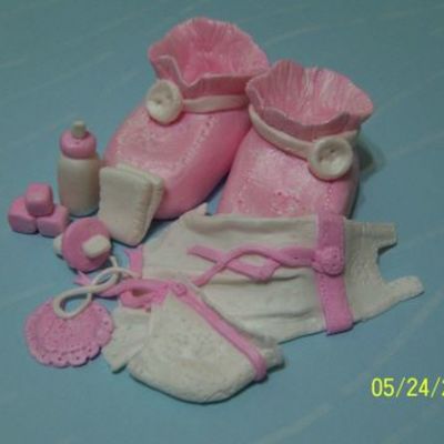 Close Up Of Girl Items On Baby Shower Cake