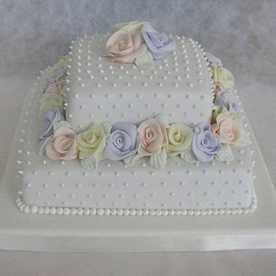 A Square Wedding Cake With Roses