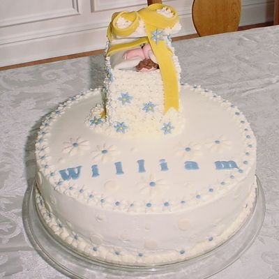 Baby "gift" Popping Out Of A White Buttercream With Fondant Blue And White Daisies