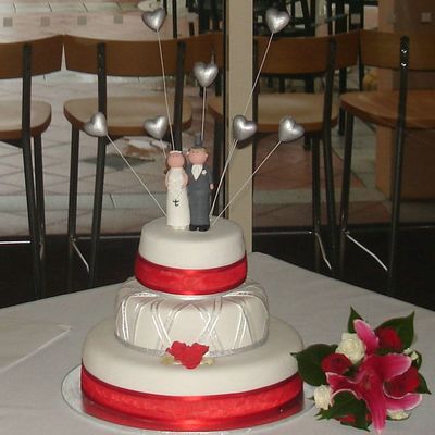 Three Tier Wedding Cake With Floating Top Tier And Silver Hearts