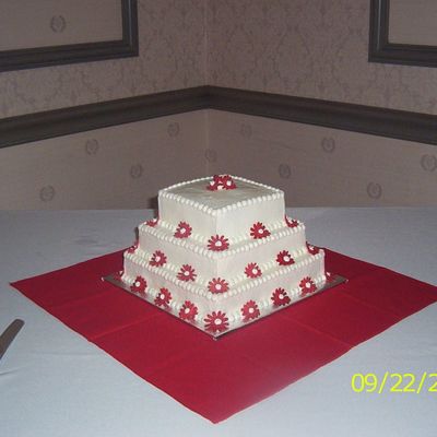 Square Wedding Cake With Red Daisies.