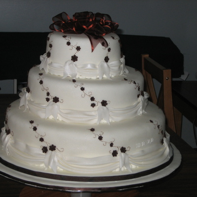 Round Wedding Cake With Brown Accent And Swags
