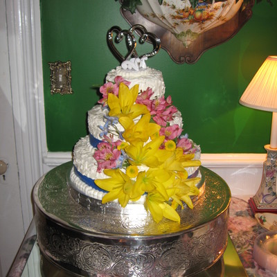 Three Tier Round Wedding With Fresh Flowers And Ribbon