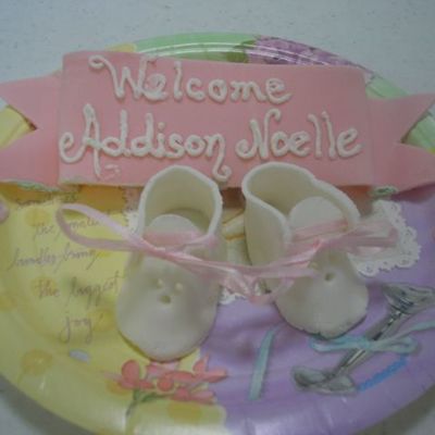 Close-Up Of Booties And Name Plaque