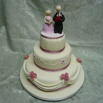 Cream And Pink Iced Three Tier Cake With Boxing Theme Cake Topper