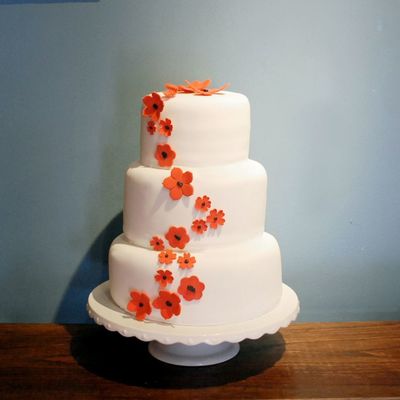 White Wedding Cake With Red And Black Flowers