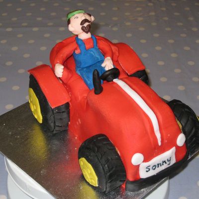 Red Tractor Cake With Farmer