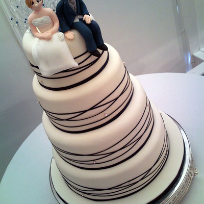 White And Midnight Blue Ribbon Wrapped Cake With Diamantes And Figures