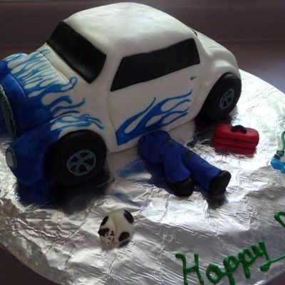 Mechanic Tinkering On A Hot Rod Car