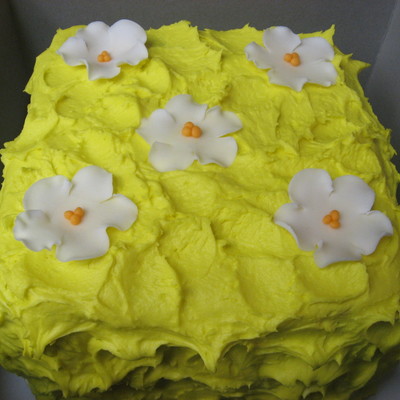 Yellow Cake With White Flowers