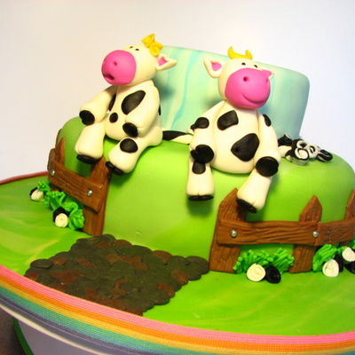 Two Little Cows Sitting On A Fence