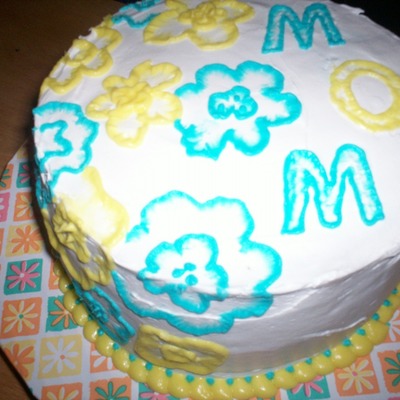 Yellow And Blue Embroidery On Whipped Cream Frosting