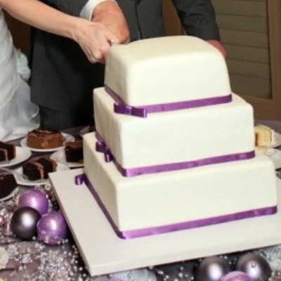 Square Wedding Cake With Purple Ribbon...