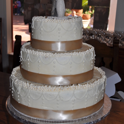 Buttercream Wedding Cake With Ivory Stringwork With Taupe Ribbon