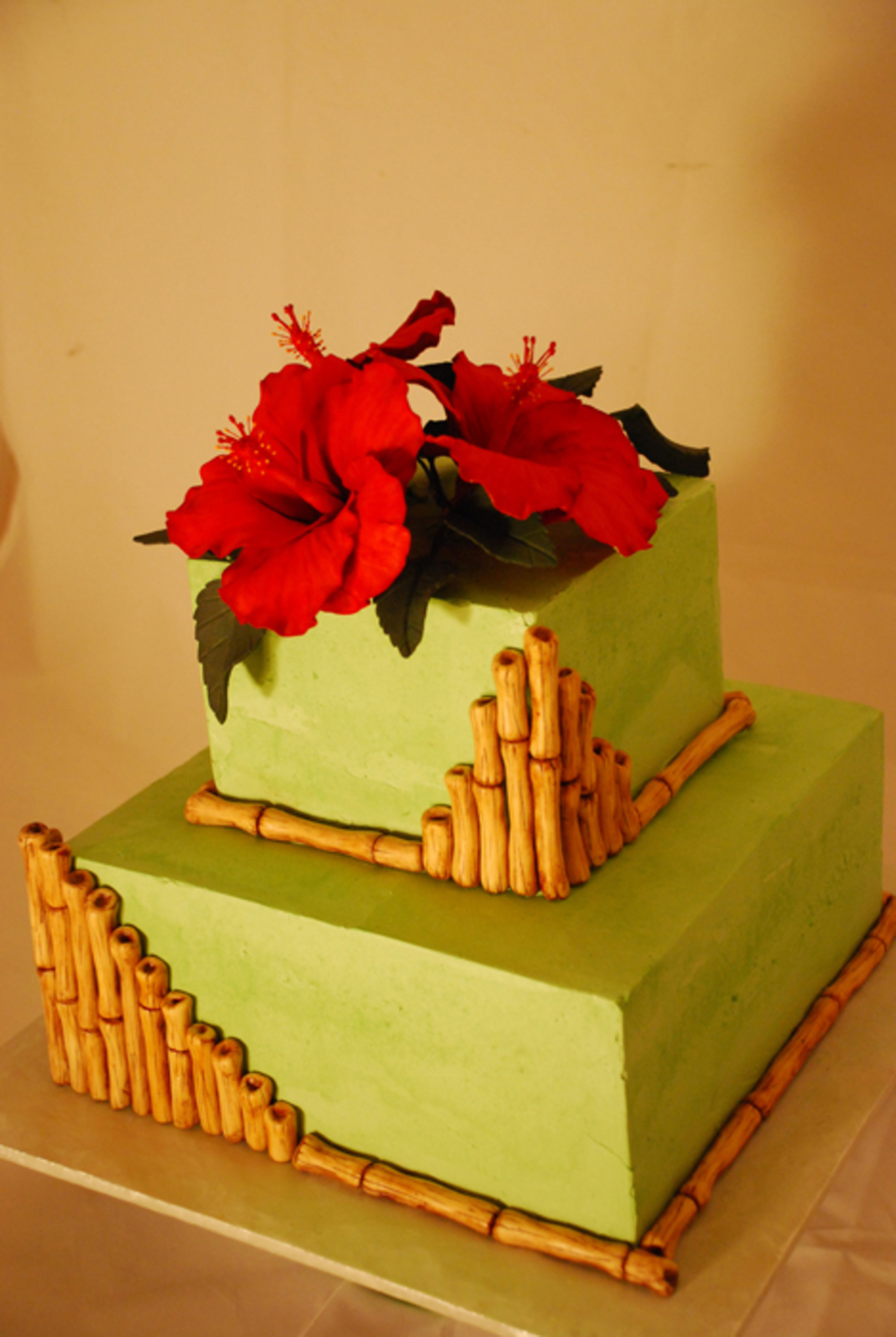 Red Hibiscus And Bamboo Green Buttercream Wedding Cake