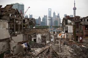 Migrant labourers work at a demolished residential site in downtown Shanghai